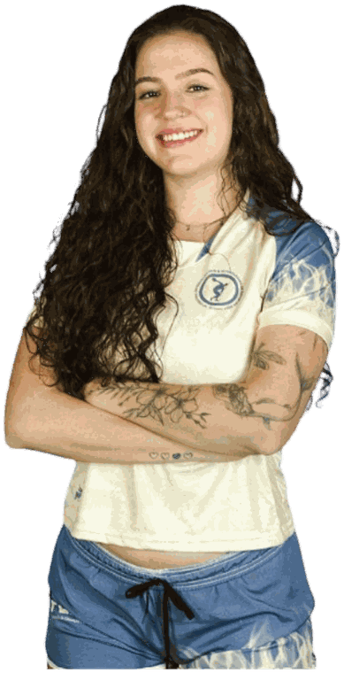 Mariana Pelegi sorrindo, de braços cruzados, com a camiseta do curso de Educação Física